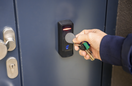 Residents entering a condominium lobby past a card reader